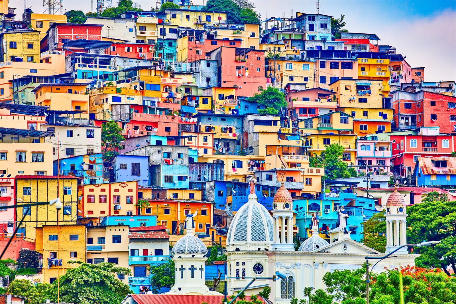 Brightly painted houses climbing a hillside in a South American port city